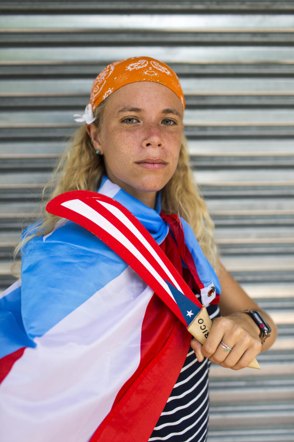 In this July 25, 2019 photo Paula Martinez poses for a portrait as people gather to celebrate the resignation of Gov. Ricardo Rossello after weeks of protests over leaked obscene, misogynistic online chats, in San Juan, Puerto Rico. The historic achievement was born out of a leaderless movement that relied heavily on social media, the appearance of music stars including Ricky Martin, Residente and Bad Bunny and an angry populace fed up with corruption. (AP Photo/Dennis M. Rivera Pichardo)