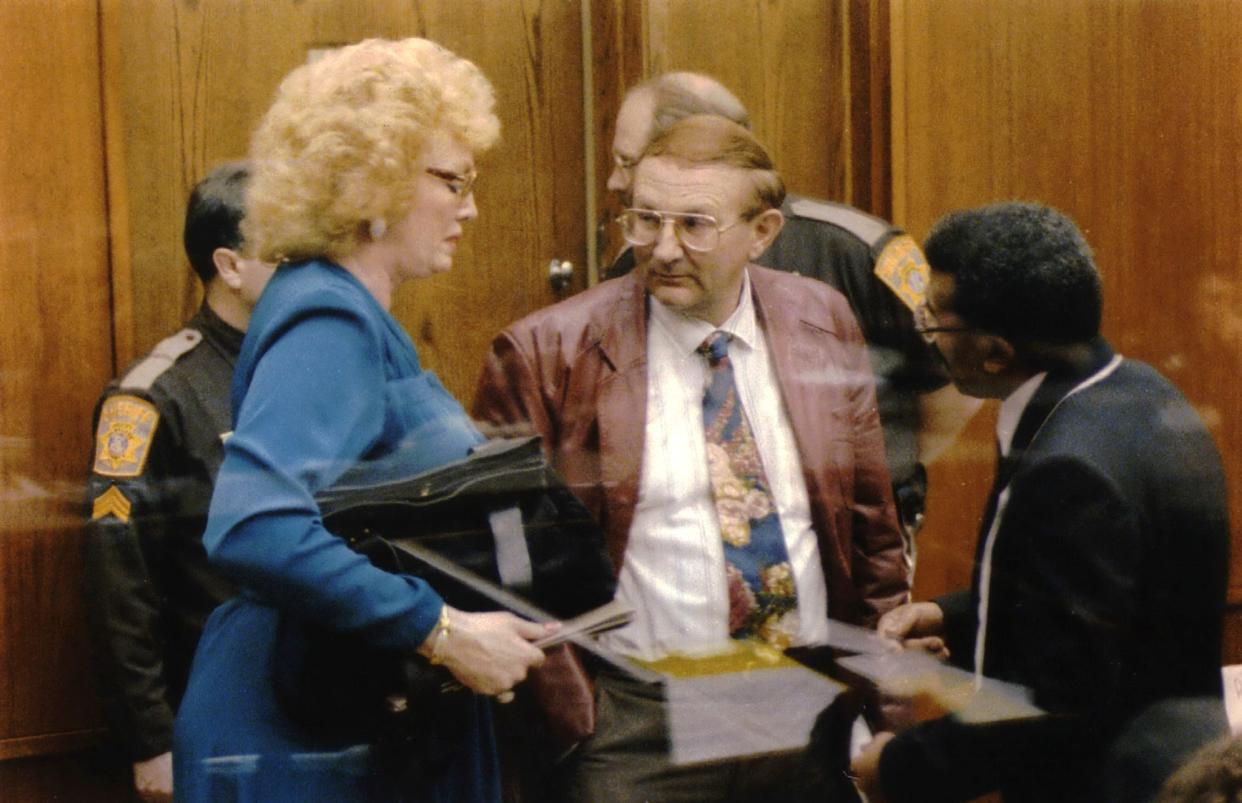 The Rev. Gene Champion (right) consoles Jeffrey L. Dahmer's stepmother and father, Shari and Lionel, during a break in testimony during Jeffrey Dahmer's sanity trial in February 1992.