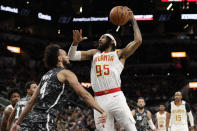 Atlanta Hawks guard DeAndre' Bembry (95) drives to the basket against San Antonio Spurs guard Derrick White (4) during the first half of an NBA basketball game in San Antonio, Friday, Jan. 17, 2020. (AP Photo/Eric Gay)