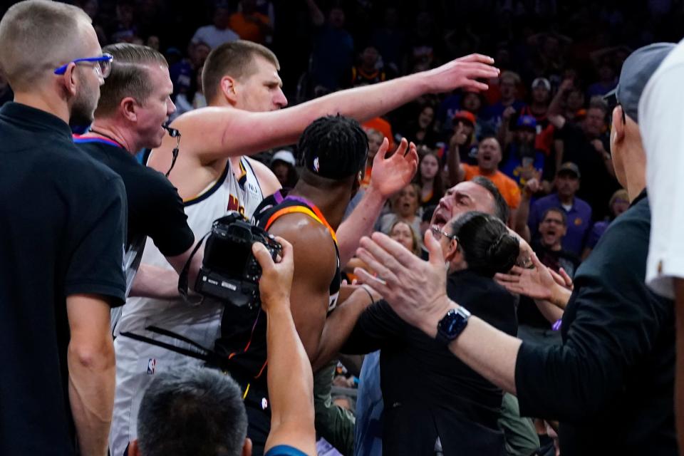 Denver Nuggets center Nikola Jokic gets into an altercation in the stands during the first half of Game 4 of the NBA Western Conference Semifinals against the Phoenix Suns at Footprint Center on May 7, 2023.