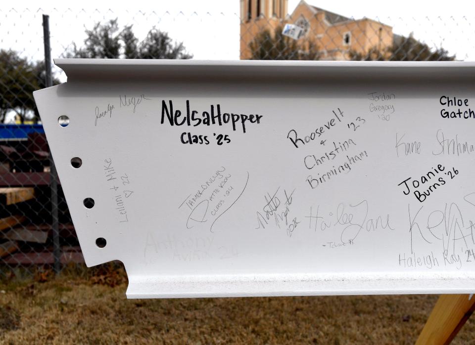 Students and alumni signatures are seen on an I-beam outside the construction site for the under-renovation Garrison Student Center at McMurry University Tuesday.