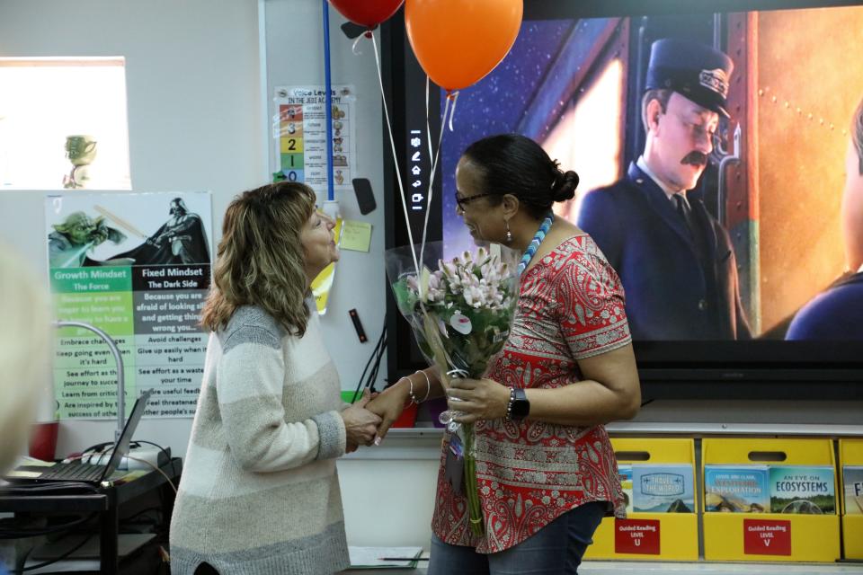 Donna Lueders, executive director of INK! (left) made a surprise visit to Sharon Warwell-Murden of R.B. Hunt Elementary School. The fifth-grade teacher is one of five finalists in INK!'s Teacher of the Year awards.