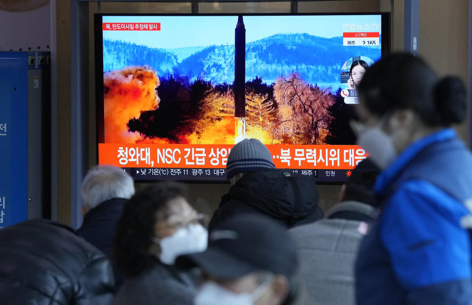 People watch a TV showing a file image of North Korea's missile launch during a news program at the Seoul Railway Station in Seoul, South Korea, Sunday, Feb. 27, 2022. North Korea on Sunday launched a suspected ballistic missile into the sea, South Korean and Japanese officials said, in an apparent resumption of its weapons tests following the end of the Winter Olympics in China, the North's last major ally and economic pipeline. The letters read " The presidential National Security Council (NSC) held an emergency meeting. (AP Photo /Ahn Young-joon)
