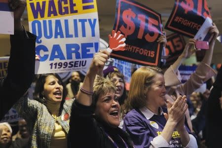 Members of the audience cheer as they listen to speakers at a union rally for higher minimum wages in New York, January 4, 2016. REUTERS/Lucas Jackson