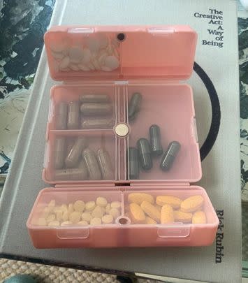 A folding pill organizer with convenient windows for easy access