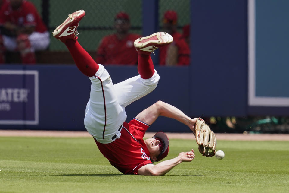 Washington Nationals right fielder Andrew Stevenson dives for but can't get to a ball hit by St. Louis Cardinals' Yadier Molina for a single in the first inning of a spring training baseball game, Wednesday, March 30, 2022, in West Palm Beach, Fla. (AP Photo/Sue Ogrocki)