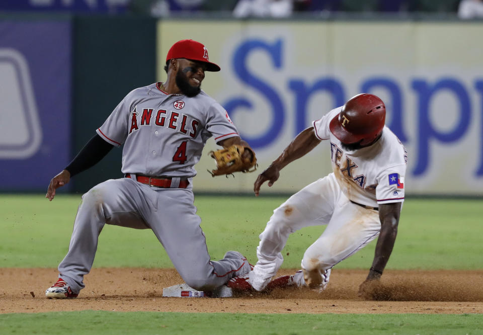 Los Angeles Angels second baseman Luis Rengifo (4) is unable to reach around to tag Texas Rangers' Delino DeShields, who stole second during the 11th inning of a baseball game in Arlington, Texas, Tuesday, Aug. 20, 2019. (AP Photo/Tony Gutierrez)