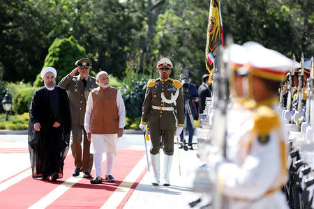 Iran's President Hassan Rouhani (L) and India's Prime Minister Narendra Modi review the honor guard during an official welcoming ceremony in Tehran, Iran May 23, 2016. President.ir/Handout via REUTERS