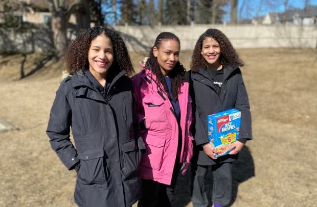 Solange Scott, middle, standing with her 13-year-old daughters Jordynn, left, and Jurnee. Scott is now asking for a public apology from Walmart after she says employees racially profiled her family, and accused her daughter of theft.  (Paul Borkwood/CBC - image credit)