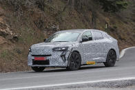 <p>This heavily camouflaged crossover from Renault is a coupé version of the Austral SUV, and will be called Rafale. The front shows a similar daytime running light setup as on the just unveiled Renault Clio facelift and the future Renault Capture facelift. The roofline of the SUV Coupe drops significantly. It’ll be unveiled at the Paris air show in June 2023.</p>