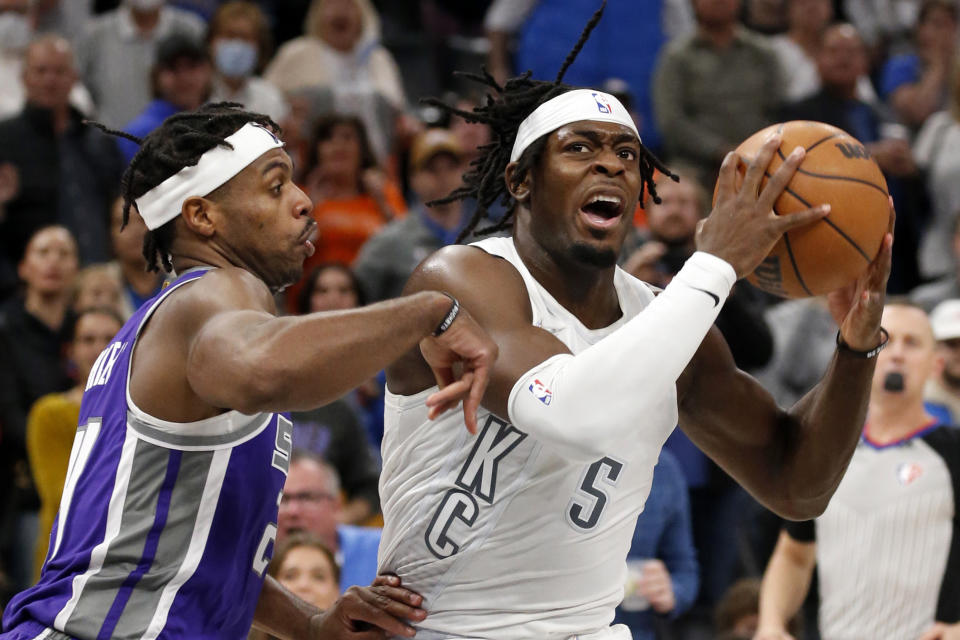 Oklahoma City Thunder forward Luguentz Dort (5) goes against Sacramento Kings guard Buddy Hield (24) in the final moments of an NBA basketball game, Friday, Nov. 12, 2021, in Oklahoma City. (AP Photo/Garett Fisbeck)