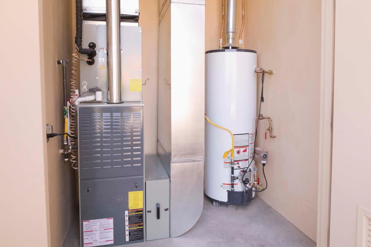 A water heater and furnace in a basement