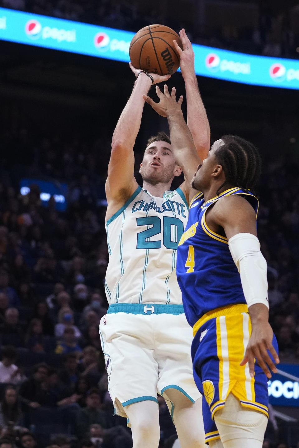 Charlotte Hornets forward Gordon Hayward (20) shoots over Golden State Warriors guard Moses Moody during the first half of an NBA basketball game in San Francisco, Tuesday, Dec. 27, 2022. (AP Photo/Godofredo A. Vásquez)