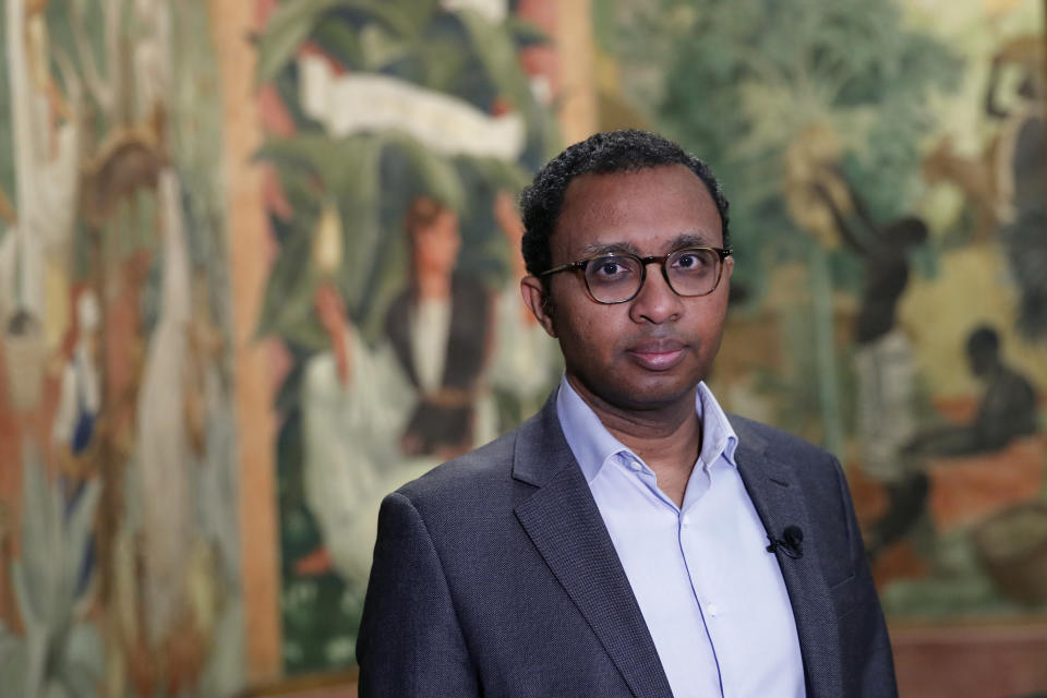 FILE - Pap Ndiaye, a Black French scholar and expert on the U.S. civil rights movement poses for a photo inside France's National Museum of the History of Immigration, in Paris, Thursday, March 11, 2021. Pap Ndiaye, was named Friday May 20, 2022 education minister. Ndiaye was previously in charge of France's state-run immigration museum. In an Associated Press interview last year, Ndiaye said France has to fight racial justice by confronting its often-violent colonial past, noting that "the French are highly reluctant to look at the dark dimensions of their own history." (AP Photo/Francois Mori, File)