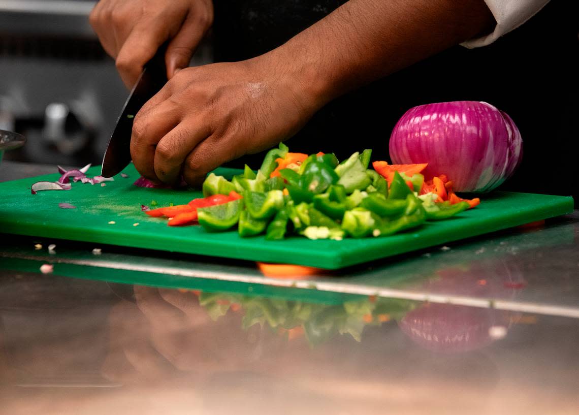Debnath Ghosh chops vegetables in the kitchen of Tamasha Modern Indian on Wednesday, May 8, 2024, in Raleigh, N.C.