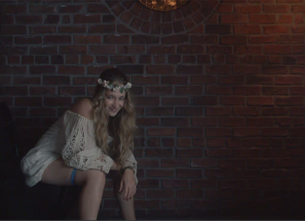 A still of Jemima Kirke of "Girls" sitting on a toilet