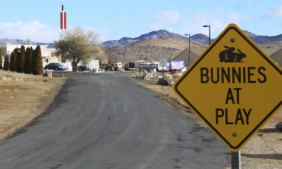 FILE - In this Feb. 27, 2019, file photo, the Moonlite Bunny Ranch brothel is seen in Lyon County east of Carson City, Nev. For nearly a year, Nevada's legal brothels have been shuttered due to the coronavirus, leaving sex workers trying to pay their bills turning to alternatives like offering "virtual dates" online or non-sexual escort services. (AP Photo/Ryan Tarinelli, File)