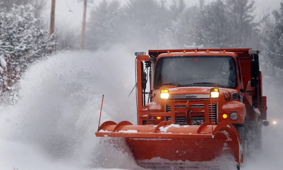 Highway crews work to clear snow from roads on Thursday, Jan. 2, 2014, in Henniker, N.H. About 6 to 10 inches of snow is expected in the southern half of New Hampshire, and up to a foot in the Seacoast area. Lesser amounts are expected farther north. The storm is expected to last into Friday morning. (AP Photo/Jim Cole)