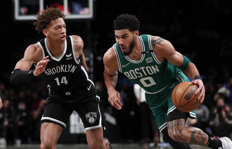 Boston Celtics forward Jayson Tatum (0) drives to the basket against Brooklyn Nets forward Kessler Edwards (14) during the first half of an NBA basketball game Thursday, Feb. 24, 2022, in New York. (AP Photo/Noah K. Murray)