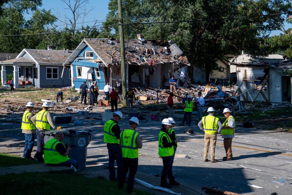 Multiple agencies work the scene the morning after a house explosion in the 1000 block of North Weinbach Avenue in Evansville, Ind., Thursday, Aug. 11, 2022. 