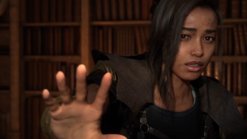 Frey, the femal protagonist of Forspoken, holds her hand up to the camera.