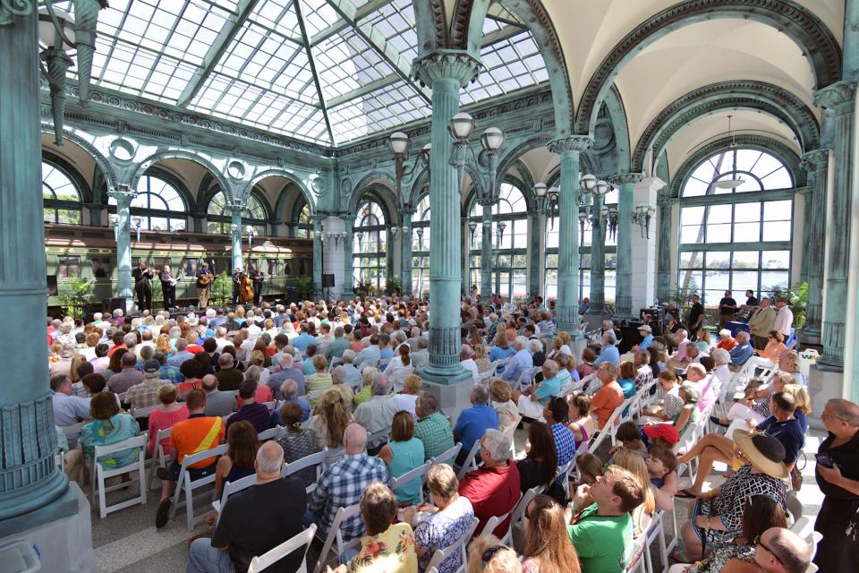 An audience in the Flagler Museum's Kenan Pavilion enjoys a previous bluegrass concert.
