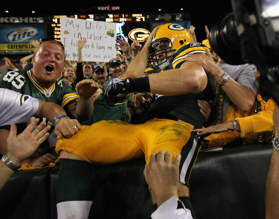 GREEN BAY, WI - SEPTEMBER 08: John Kuhn #30 of the Green Bay Packers leaps into the stands after scoring a touchdown against the New Orleans Saints during the NFL opening season game at Lambeau Field on September 8, 2011 in Green Bay, Wisconsin. (Photo by Jonathan Daniel/Getty Images)