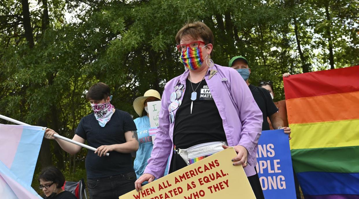 <span class="caption">Parents and activists who support transgender rights rally before a school board meeting on Aug. 10, 2021, in Ashburn, Virginia.</span> <span class="attribution"><a class="link " href="https://www.gettyimages.com/detail/news-photo/charlotte-mcconnell-of-sterling-va-leads-a-rally-of-parents-news-photo/1234616774?adppopup=true" rel="nofollow noopener" target="_blank" data-ylk="slk:Ricky Carioti/The Washington Post via Getty Images;elm:context_link;itc:0;sec:content-canvas">Ricky Carioti/The Washington Post via Getty Images</a></span>