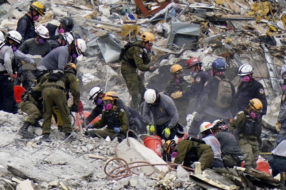 FILE - Crews from the United States and Israel work in the rubble Champlain Towers South condo, Tuesday, June 29, 2021, in Surfside, Fla. The Israeli search and rescue team that arrived in South Florida shortly after the Champlain Towers South collapsed last month is heading home after an emotional sendoff in Surfside. The team planned to leave Florida on Sunday, July 11. During a brief Saturday evening ceremony, Miami-Dade Mayor Daniella Levine Cava thanked the battalion for their “unrelenting dedication." (AP Photo/Lynne Sladky, File)