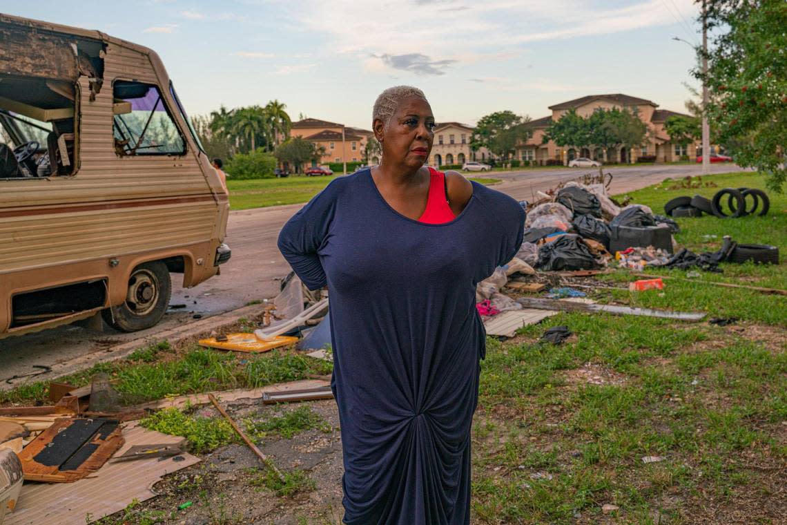 Resident Sonya Brown poses for a portrait as she looks at trash in the empty lot on Northwest 74th Street and Northwest 25th Avenue in Miami, Florida, on Wednesday, Nov. 30, 2022.