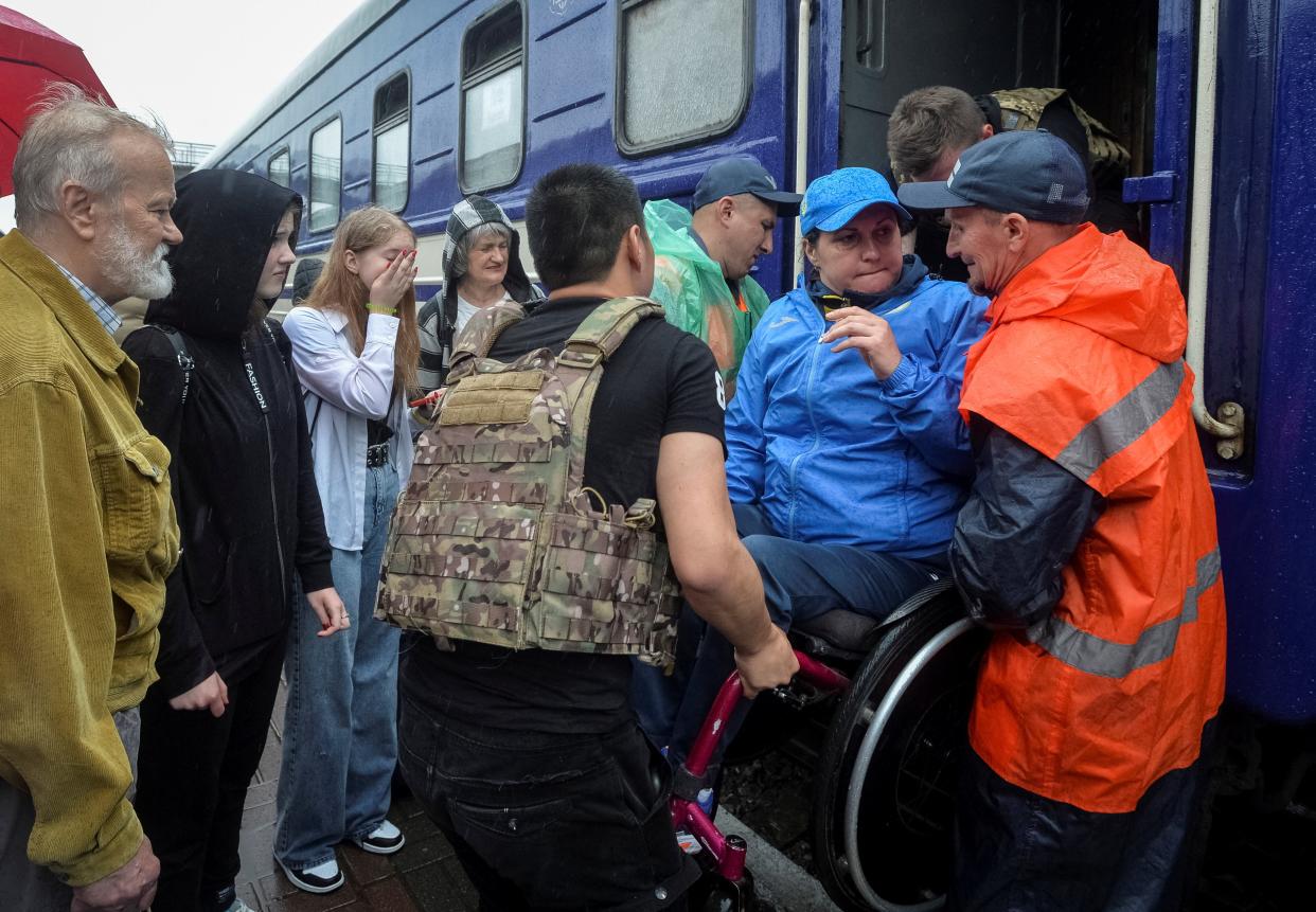 Local residents board an evacuation train after the Nova Kakhovka dam breach in Kherson, Ukraine, 11 June 2023 (REUTERS)