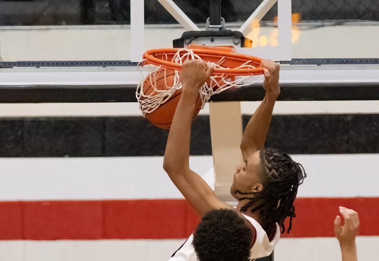 McKinley’s Reed Sims Jr. dunks against St. Vincent-St. Mary on Friday, Dec. 22, 2023.