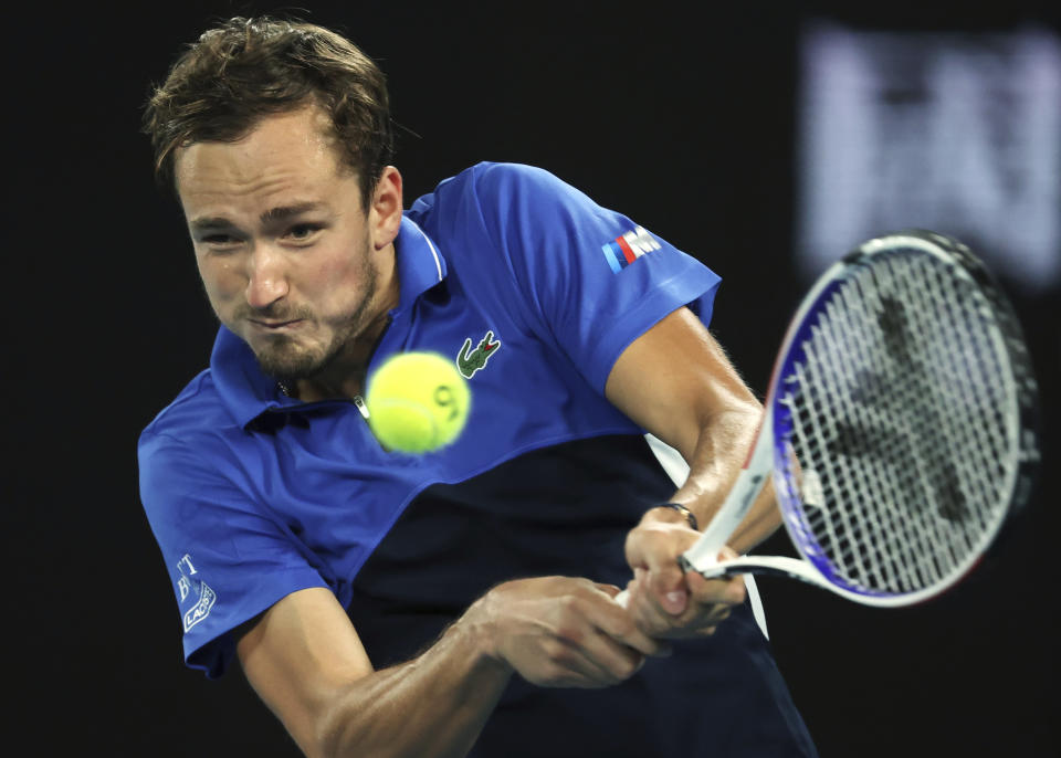 Russia's Daniil Medvedev makes a backhand return to Frances Tiafoe of the U.S. during their first round singles match at the Australian Open tennis championship in Melbourne, Australia, Tuesday, Jan. 21, 2020. (AP Photo/Lee Jin-man)
