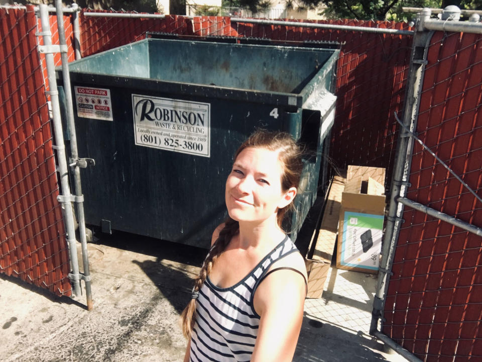 Stacey Cole pictured in front of an industrial bin. The mum of four said she's taken to dumpster diving to save $200 a month on the grocery bill.