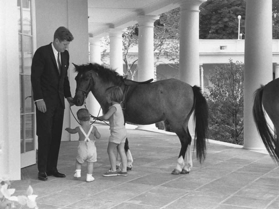 President John F. Kennedy greets his children and Caroline’s pony Macaroni in 1962.