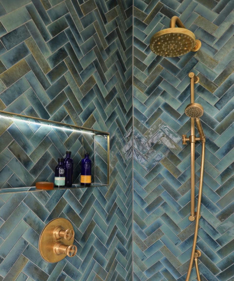 blue rustic herringbone style tiles and gold brushed hardware