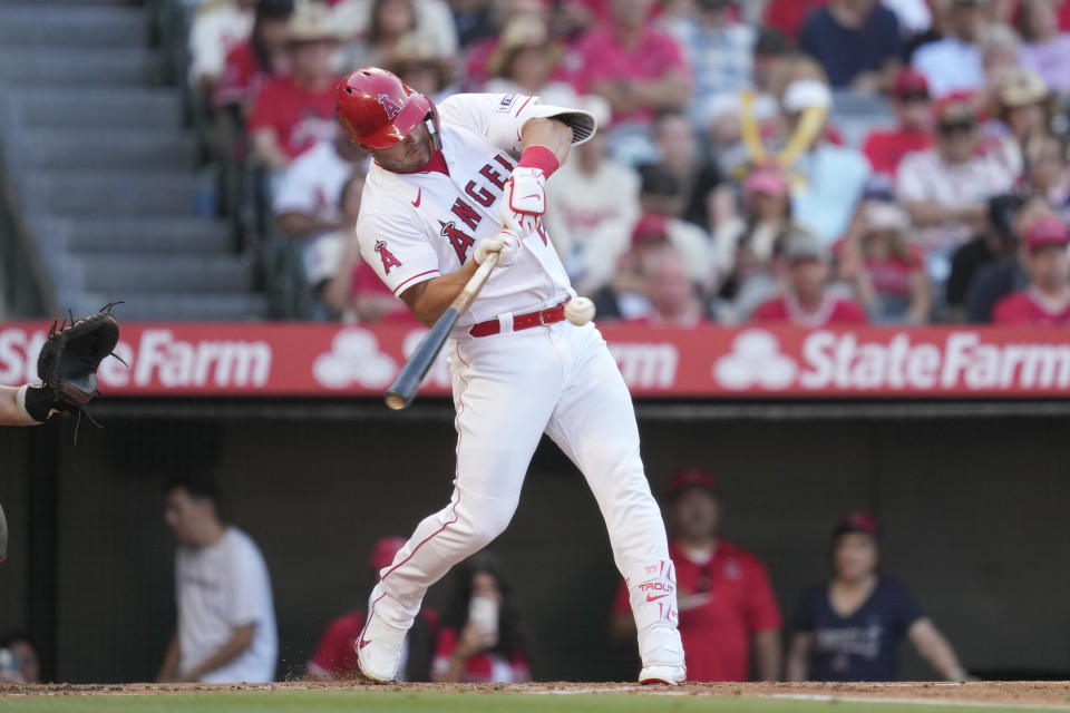Los Angeles Angels' Mike Trout (27) singles during the first inning of a baseball game against the Arizona Diamondbacks in Anaheim, Calif., Friday, June 30, 2023. (AP Photo/Ashley Landis)