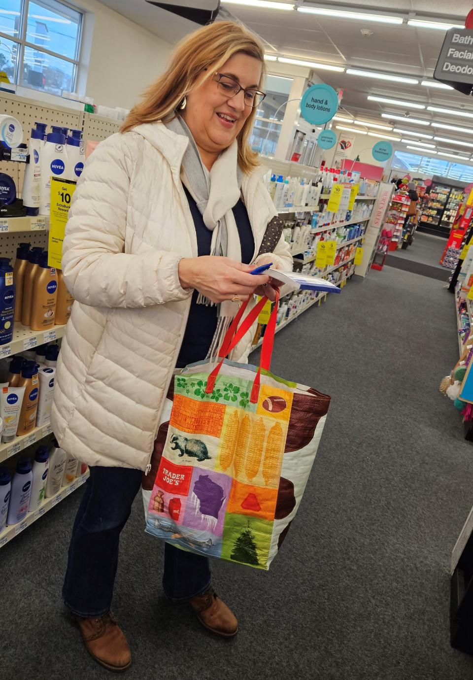 Erin Hunsader checks the shopping list of a senior client as she looks for requested items at the CVS pharmacy in Sturgeon Bay while performing the job of her new business, Erin's Errands.