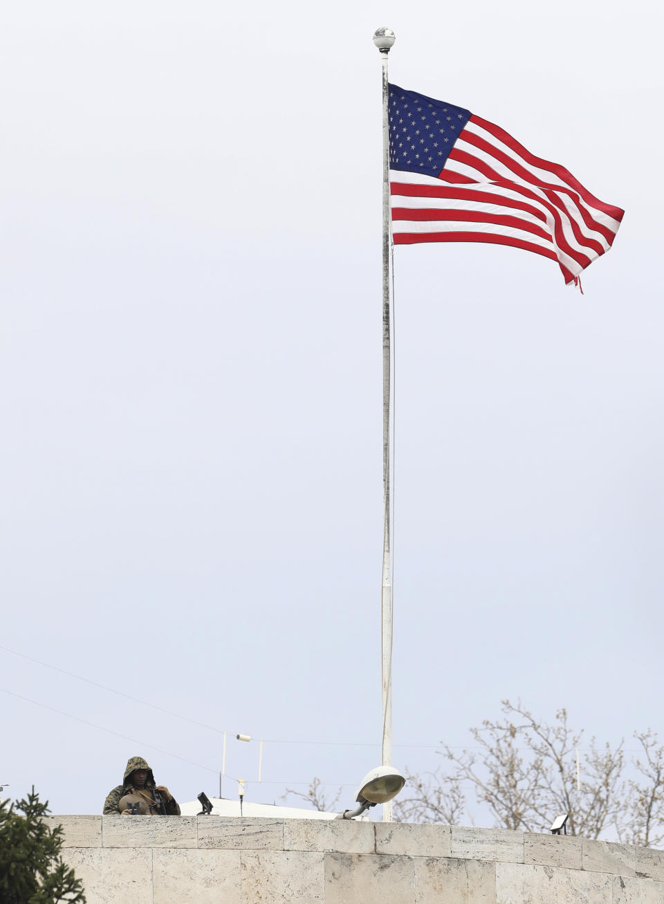 A U.S. soldier stands guard on the rooftop of the United States embassy in Ankara, Turkey, Sunday, April 25, 2021. Turkey's foreign ministry has summoned the U.S. Ambassador in Ankara to protest the U.S. decision to mark the deportation and killing of Armenians during the Ottoman Empire as "genocide." On Saturday, U.S. President Joe Biden followed through on a campaign promise to recognize the events that began in 1915 and killed an estimated 1.5 million Ottoman Armenians as genocide. (AP Photo/Burhan Ozbilici)