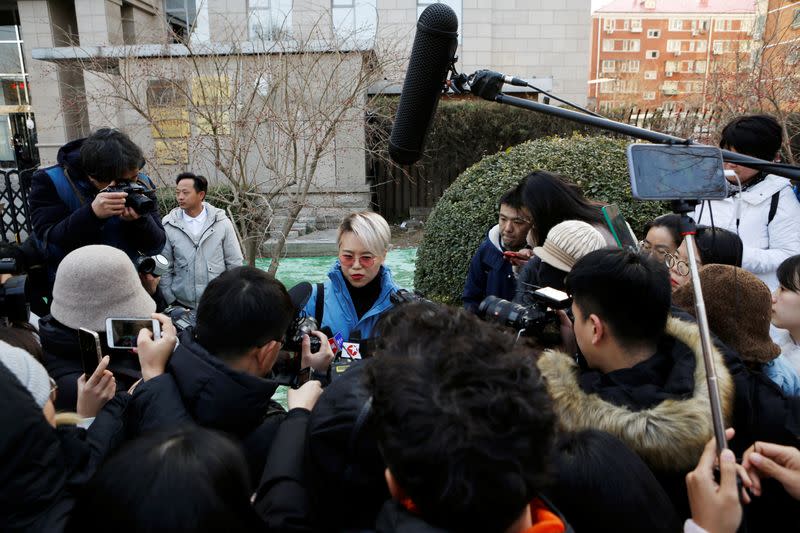 Teresa Xu speaks to journalists outside Chaoyang People's Court after a court hearing in Beijing