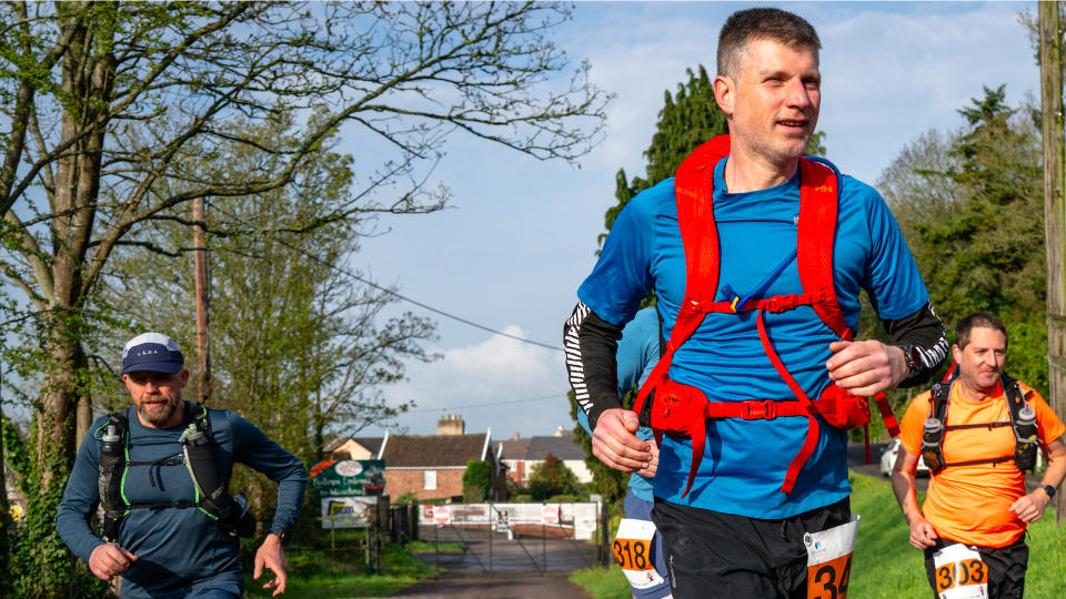 Man wearing a Helly Hansen Transistor Backpack while running