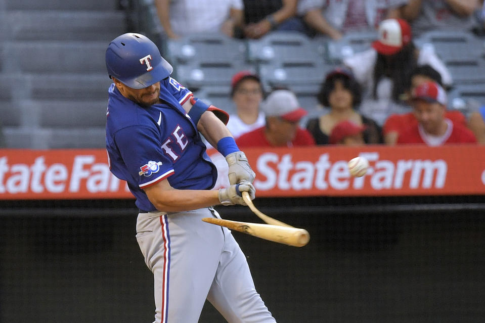 Texas Rangers' Nick Solak breaks his bat as he hits a single during the third inning of a baseball game against the Los Angeles Angels Friday, July 29, 2022, in Anaheim, Calif. (AP Photo/Mark J. Terrill)