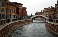 A bridge crosses a canal that flows through the center of the Florentia Village in the district of Wuqing, located on the outskirts of the city of Tianjin, China, June 13, 2012. The shopping center, which covers an area of some 200,000 square meters, was constructed on a former corn field at an estimated cost of US$220 million and copies old Italian-style architecture with Florentine arcades, a grand canal, bridges, and a building that resembles a Roman Coliseum. <br><br><a href="http://news.yahoo.com/photos/china-replicates-austrian-village-slideshow/" data-ylk="slk:Click here;elm:context_link;itc:0;sec:content-canvas;outcm:mb_qualified_link;_E:mb_qualified_link;ct:story;" class="link  yahoo-link">Click here</a> to see a related gallery: China replicates Austrian village