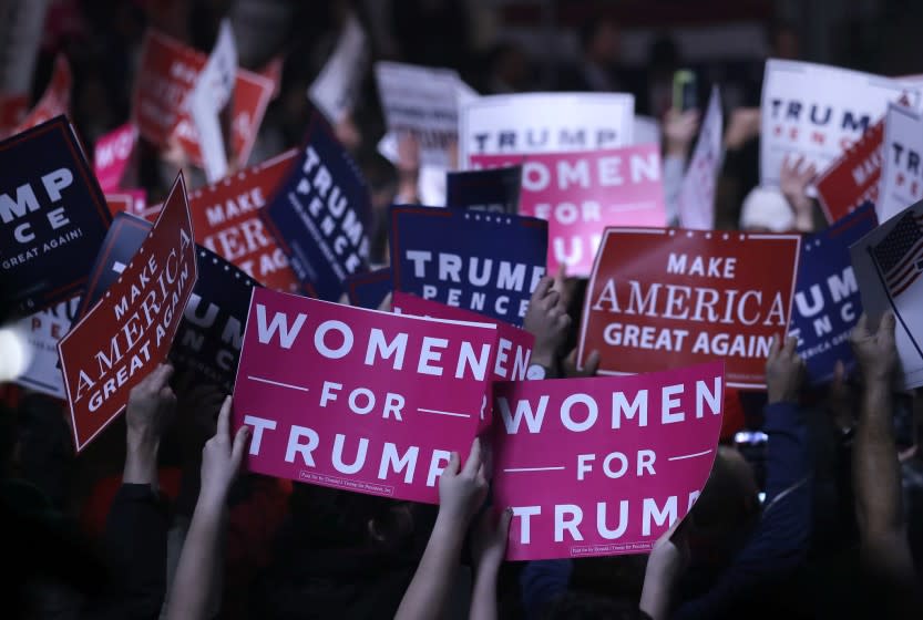 Supporters hold "Women for Trump" signs before a campaign rally for Republican presidential candidate Donald Trump, Monday, Nov. 7, 2016, in Manchester, N.H. (AP Photo/Charles Krupa)