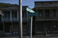 Abandoned shops line Main Street in Shawnee, Ohio, on Friday, July 24, 2020, near abandoned homes, empty schools and boarded-up churches. Shawnee was a coal town that once boasted an opera house, a vaudeville theater, dozens of stores and plenty of taverns. (AP Photo/Wong Maye-E)