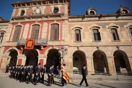Mossos d'Esquadra (Catalan regional police officers) in gala uniforms walk past parliament building after the first session of Catalan parliament in Barcelona, Spain, January 17, 2018. REUTERS/Albert Gea