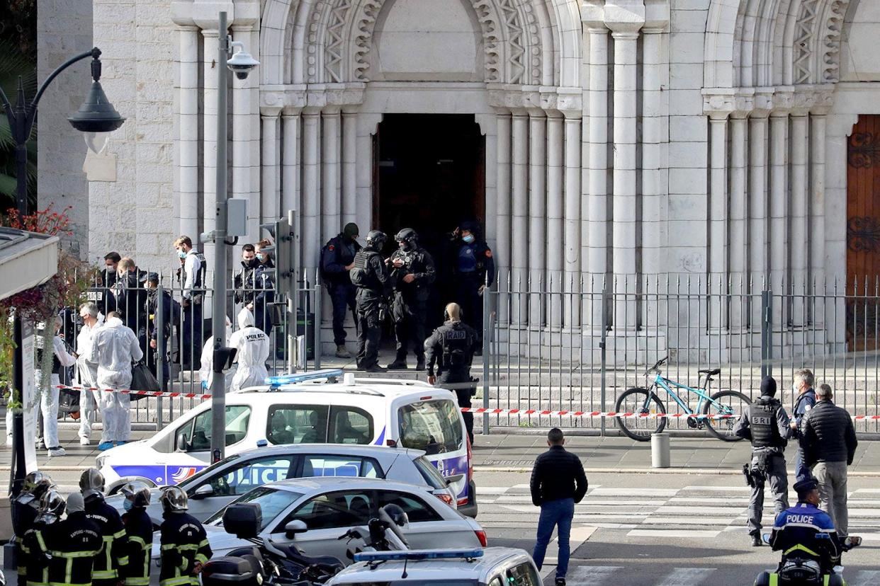 French members of the elite tactical police unit RAID enter to search the Basilica of Notre-Dame de Nice after a knife attack: AFP via Getty Images