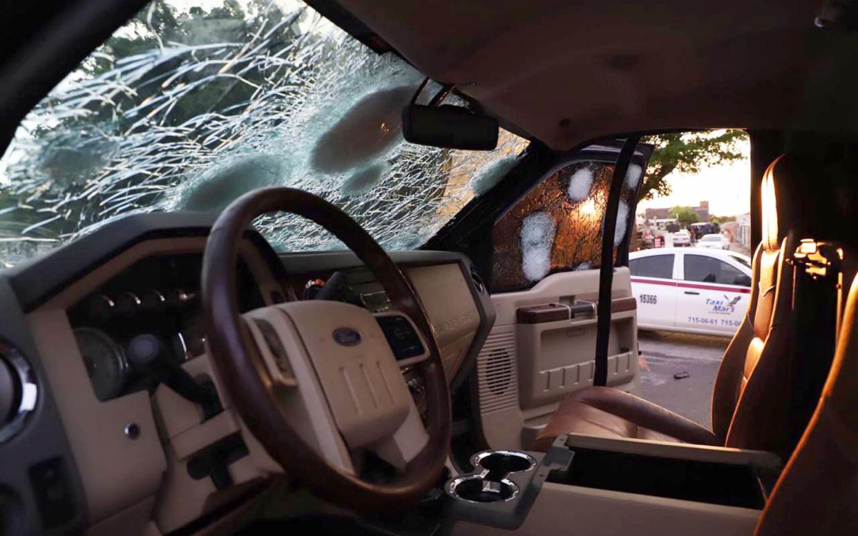 A bullet-ridden vehicle remains on the street of Culiacan, in the Mexican state of Sinaloa, following a shootout between armed gunmen and Mexican security forces.  - AFP