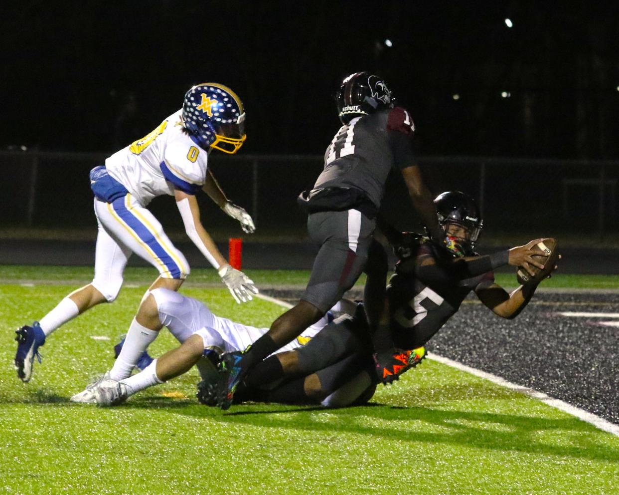 Harvest Prep’s E.J. Pierce stretches across the goal line for a touchdown during Friday’s 24-0 win over West Muskingum in Division V, Region 19.