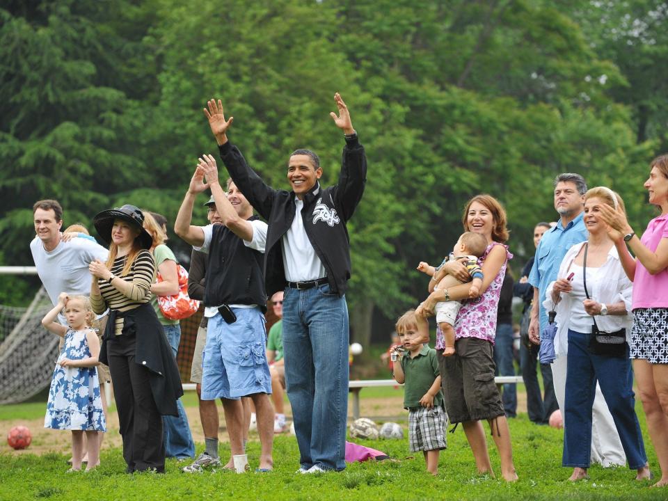 President Obama celebrating with his arms in the air after his daughter's soccer team scored a goal in 2009.